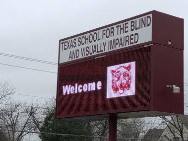 Large School Street Sign with Texas School for the Blind and Visually Impaired and the Words Welcome