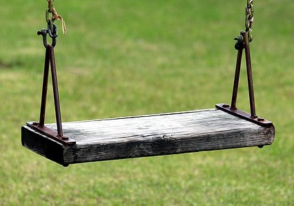 Wooden swing seat with chain link.