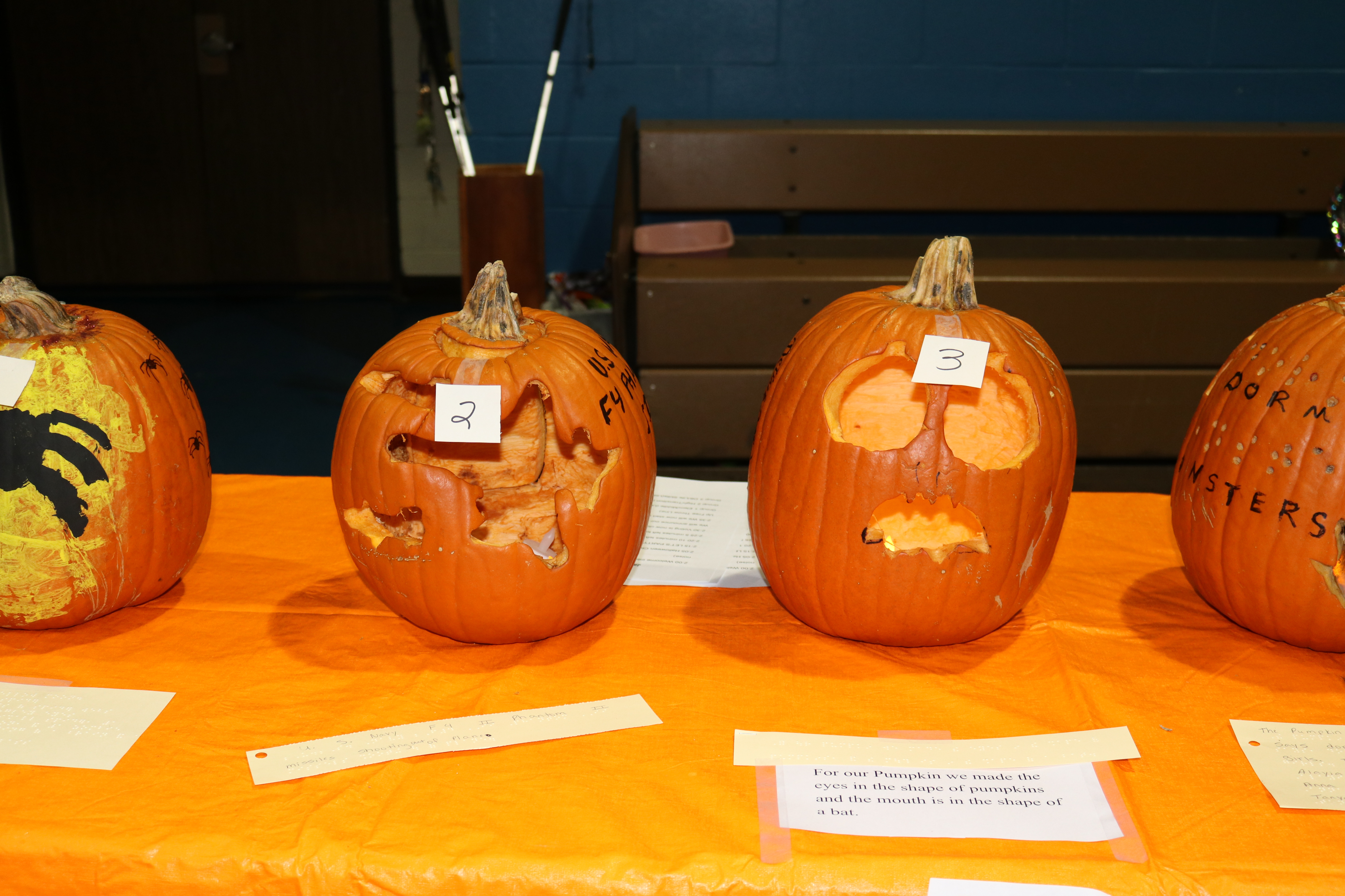 Four carved pumpkins on display.