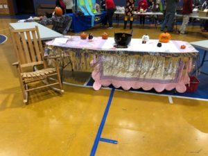 table set up as a story book table with rocking chair on the left