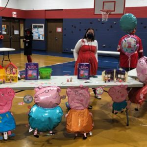 Ms. Hillary's And Her Table Decorated With Peppa Pig Balloons And Items