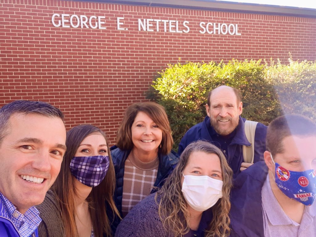 6 teachers standing outside a building with the words George E. Nettles School