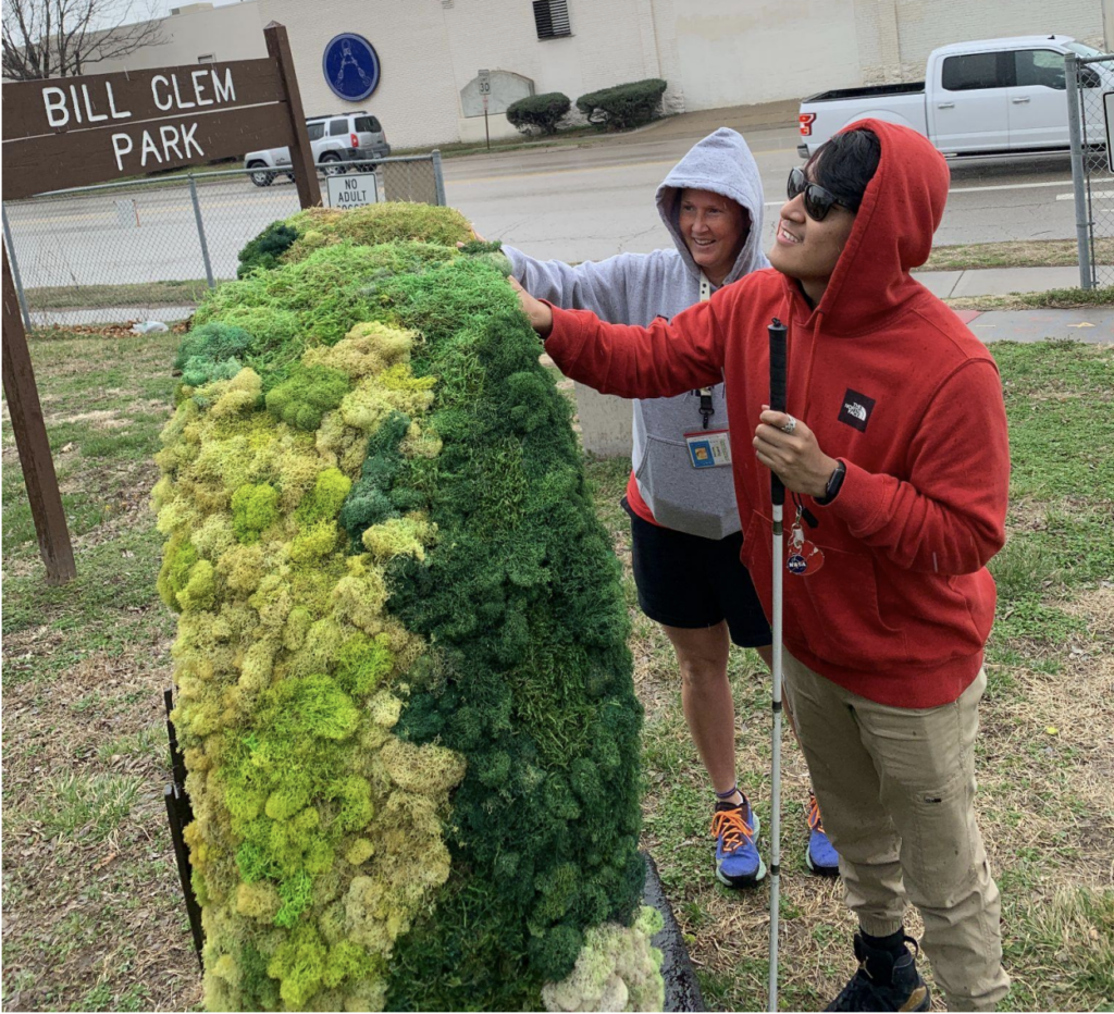 Ms. Nicole and Gabe feel the moss on the large heart in Bill Crew Park, this is one of the hearts in the Kansas City Parade of Hearts